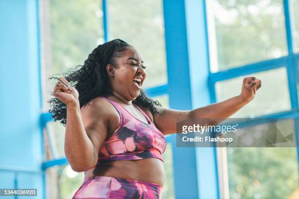 portrait of a woman exercising at the gym - females laughing stock pictures, royalty-free photos & images