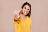 Smiling woman point finger at you