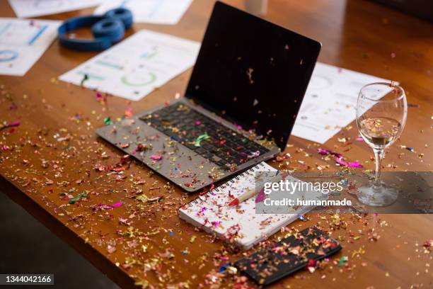 broom cleaning confetti after new year's office party - business party stockfoto's en -beelden