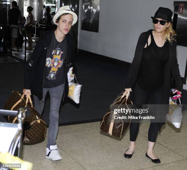 Actress Lindsay Lohan and Samantha Ronson arrive at the Miami International Airport on August 6, 2008 in Miami, Florida.