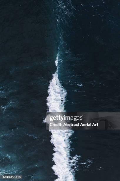 drone shot looking down on a breaking ocean wave, iceland - rip tide stock pictures, royalty-free photos & images