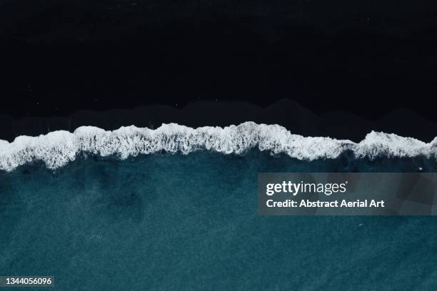 aerial shot showing reynisfjara black sand beach and ocean waves, vik, iceland - black sand stock pictures, royalty-free photos & images