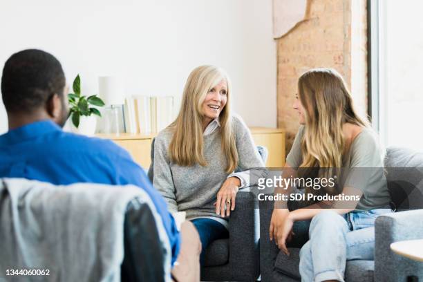 mother and daughter find hope and reconciliation in therapy - family mediation stock pictures, royalty-free photos & images
