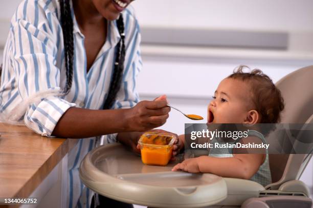 mother feeding her child. - baby food stock pictures, royalty-free photos & images