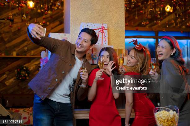 christmas party with friends. - dinner christmas selfie stock pictures, royalty-free photos & images