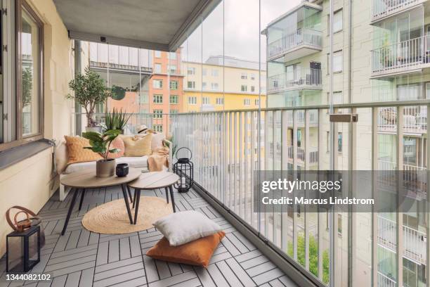 large glass enclosed balcony - outdoor furniture stock pictures, royalty-free photos & images