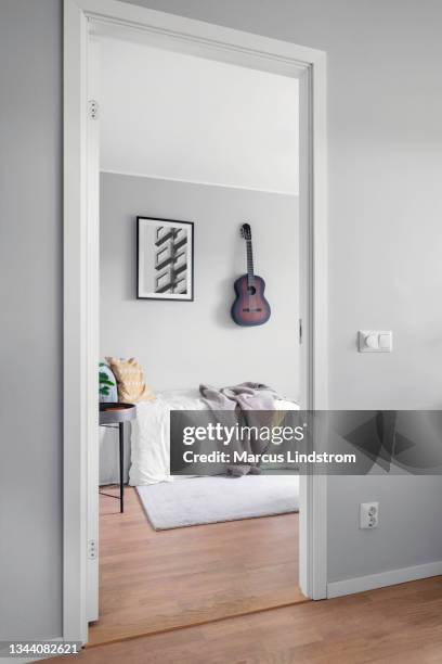 a small bedroom viewed through a doorway - bedroom door stock pictures, royalty-free photos & images