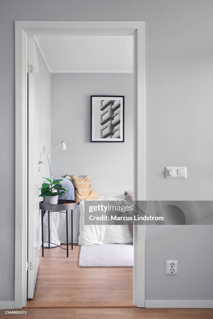 View into a modern guest room through a doorway