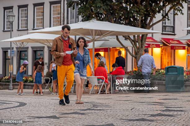 young couple in front of a street restaurant - ponta delgada stock pictures, royalty-free photos & images