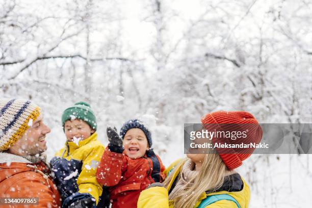 happy family in the winter wonderland - winter stock pictures, royalty-free photos & images