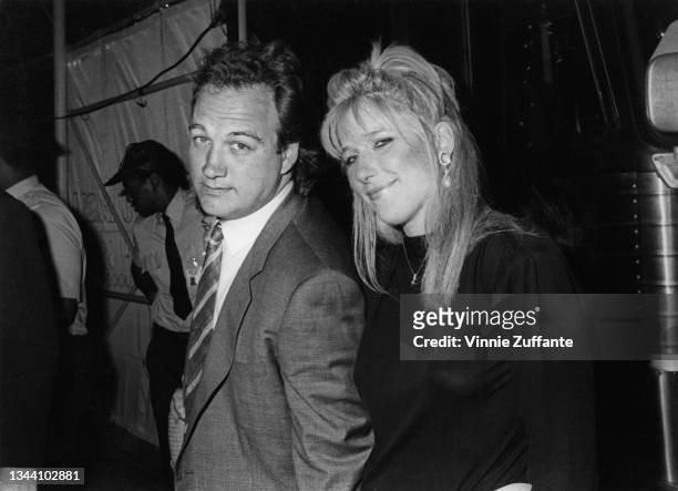 American actor James Belushi and an unspecified woman attend the New York premiere of 'About Last Night' held at the 23rd Street West Triplex Theater...