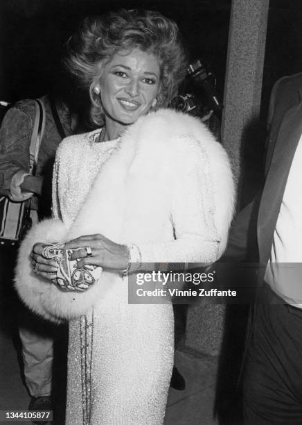 British actress Stephanie Beacham, wearing a white evening gown with a white fur stole, attends the 12th People's Choice Awards, held at the Santa...