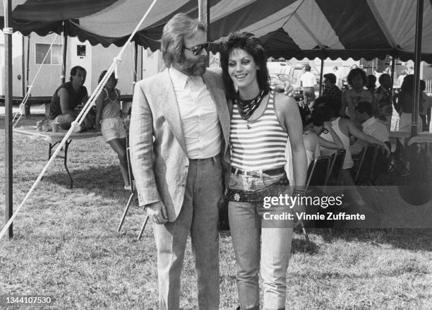 American singer, songwriter, and musician Carl Wilson with American singer, songwriter, and musician Joan Jett backstage at the 'Sea To Shining Sea'...
