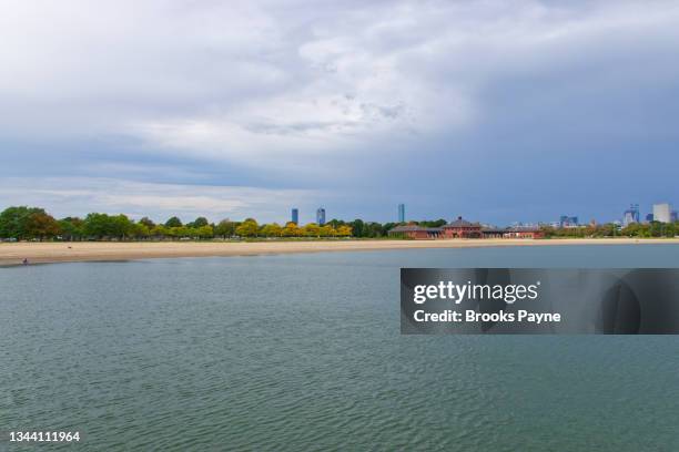 early fall foliage at carson beach and old harbor - dorchester stock-fotos und bilder