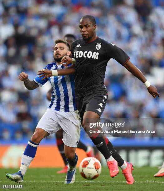 Portu of Real Sociedad battles for possession with Djibril Sidibe of Monaco during the UEFA Europa League group B match between Real Sociedad and AS...