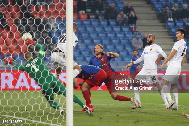 Michael Lang of FC Basel scores their side's second goal past Stas Pokatilov of Kairat during the UEFA Europa Conference League group H match between...