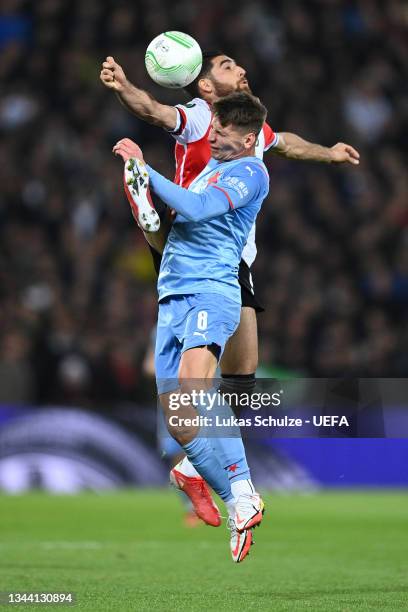 Lukas Masopust of Slavia Prague competes for a header with Alireza Jahanbakhsh of Feyenoord during the UEFA Europa Conference League group E match...