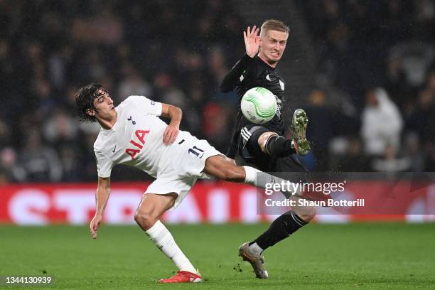 Bryan Gil of Tottenham Hotspur tackles Zan Karnicnik of NS Mura during the UEFA Europa Conference League group G match between Tottenham Hotspur and...