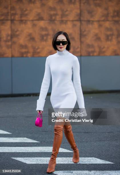 Chriselle Lim seen wearing white dress, brown boots, pink bag outside Coperni during Paris Fashion Week - Womenswear Spring Summer 2022 on September...