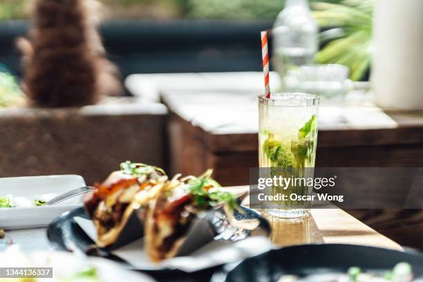 mojito with grilled steak tacos - mexican food on table stock pictures, royalty-free photos & images