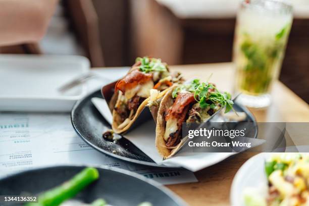 mexican cuisine, grilled steak tacos for sharing - taco stockfoto's en -beelden