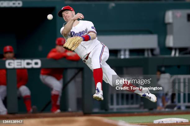 Brock Holt of the Texas Rangers fields a ground ball hit by Jack Mayfield of the Los Angeles Angels in the top of the fifth inning at Globe Life...