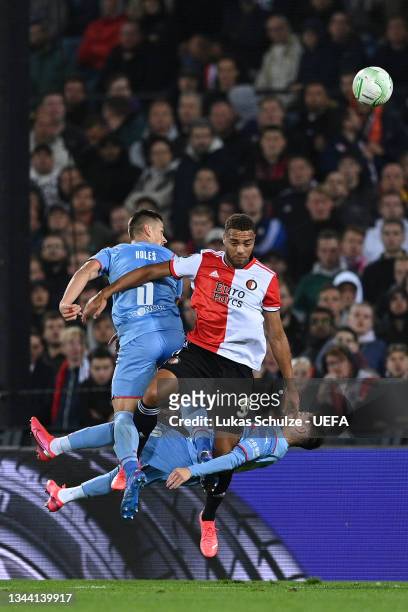 Cyriel Dessers of Feyenoord competes for a header with Tomas Holes and Srdjan Plavsic of Slavia Prague during the UEFA Europa Conference League group...