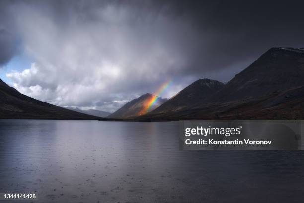 northern nature landscape. rainbow over the mountains. raindrops in the lake. - 2021 hope stock pictures, royalty-free photos & images