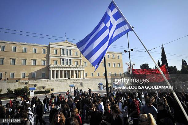 People march in front of the Greek Parliament during a protest in Athens marking the 24-hours general strike on December 1, 2011. Greece's new...