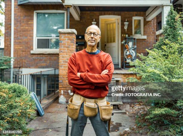 senior man doing carpentry outdoors - renovering bildbanksfoton och bilder