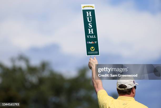 Volunteer holds a Hush Y'all sign during round one of the Sanderson Farms Championship at Country Club of Jackson on September 30, 2021 in Jackson,...