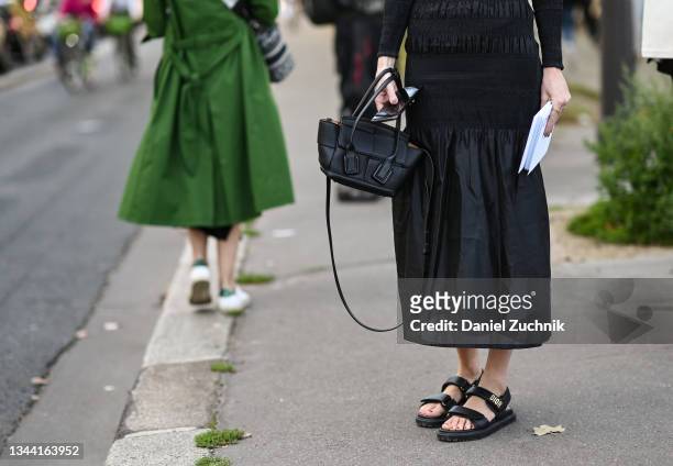 Tiernan Cowling is seen wearing a black Chloe dress with Dior sandals outside the Chloe show during Paris Fashion Week S/S 2022 on September 30, 2021...