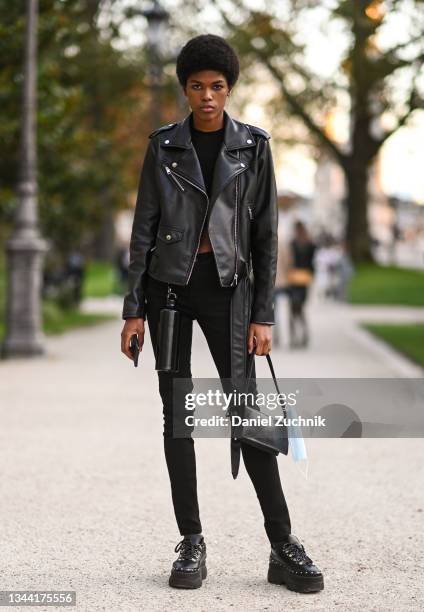 Model Raysa de Jesus is seen wearing a leather jacket, black pants and black bag outside the Rokh show during Paris Fashion Week S/S 2022 on...