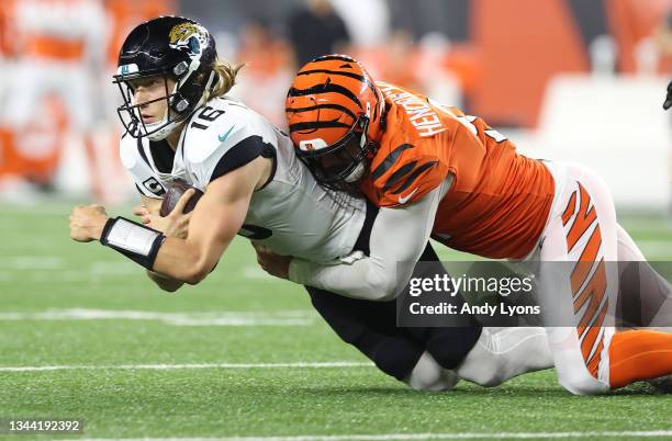 Trevor Lawrence of the Jacksonville Jaguars is sacked by Trey Hendrickson of the Cincinnati Bengals during the second half of an NFL football game at...