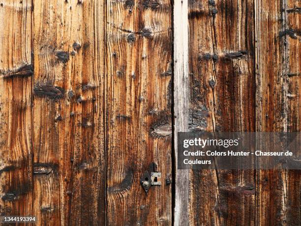 wooden door of an old barn in haute-savoie - rustic cabin stock pictures, royalty-free photos & images