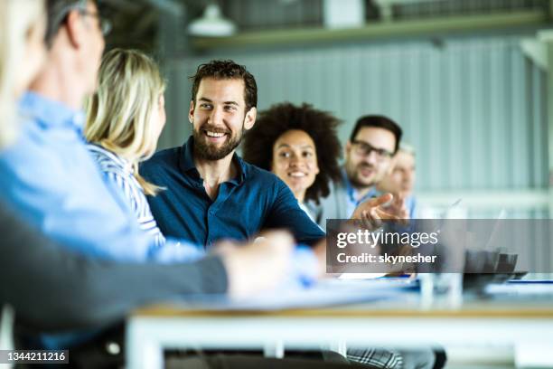 large group of happy business colleagues talking on a meeting in the office. - work culture stock pictures, royalty-free photos & images