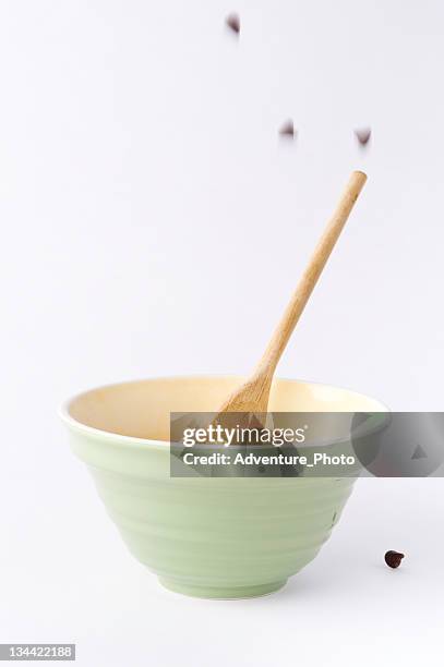 falling chocolate chips and mixing bowl ingredients - mixing bowl stock pictures, royalty-free photos & images