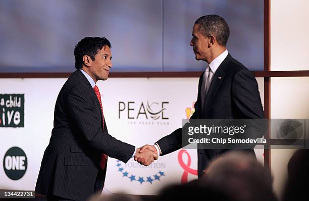 Chief Medical Correspondent Dr. Sanjay Gupta welcomes U.S. President Barack Obama to the stage during a World AIDS Day event at the Jack Morton...