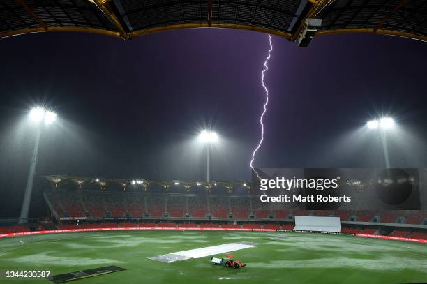 Lightning is seen during a rain delay on day two of the Women's International Test match between Australia and India at Metricon Stadium on October...