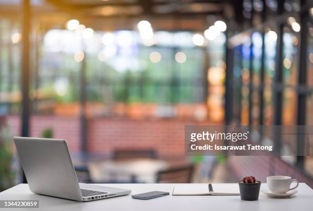 laptop with blank screen and smartphone on table. - focus on foreground stock pictures, royalty-free photos & images