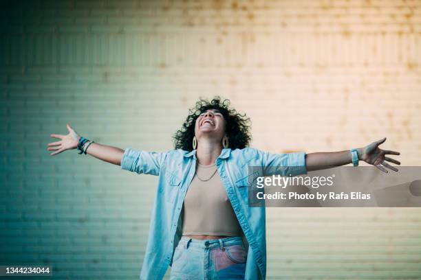 happy woman with wide open arms - winners podium people stock pictures, royalty-free photos & images
