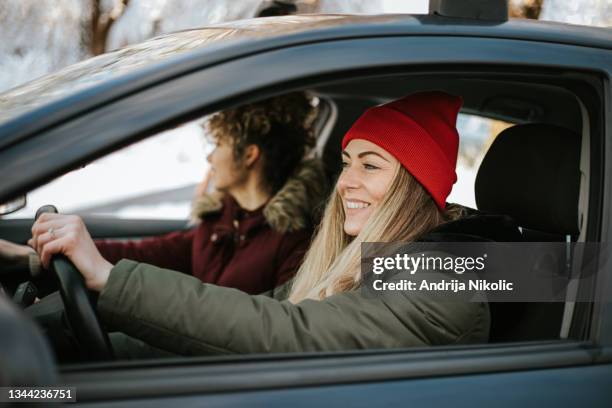 two female friends enjoying their weekend getaway - driving stock pictures, royalty-free photos & images
