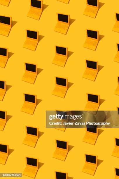 some yellow laptops on yellow background - repetition office stock pictures, royalty-free photos & images