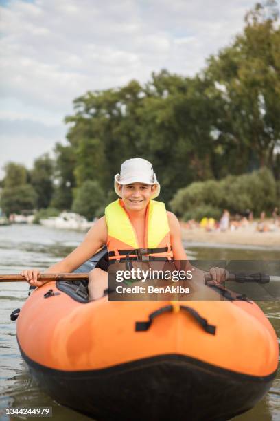 teenager having fun kayaking on a lake - alpha males stock pictures, royalty-free photos & images