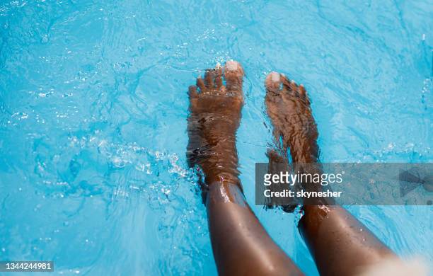 nahaufnahme der beine einer afroamerikanischen frau im pool. - african american women wet stock-fotos und bilder