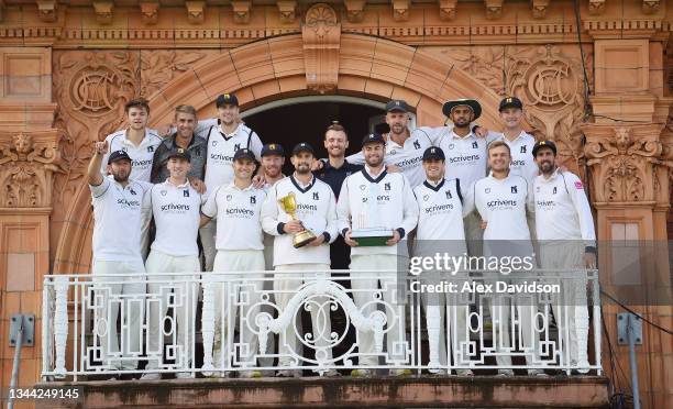 Will Rhodes and his Warwickshire teammates pose with the Bob Willis Trophy and County Championship after Day 4 of the Bob Willis Trophy Final between...