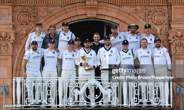 Will Rhodes and Dom Sibley hold the two trophies with the other Warwickshire players after they won the Bob Willis Trophy Final against Lancashire at...