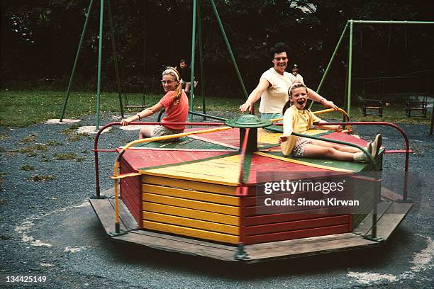 children & mother on roundabout - archival 1960s stock pictures, royalty-free photos & images