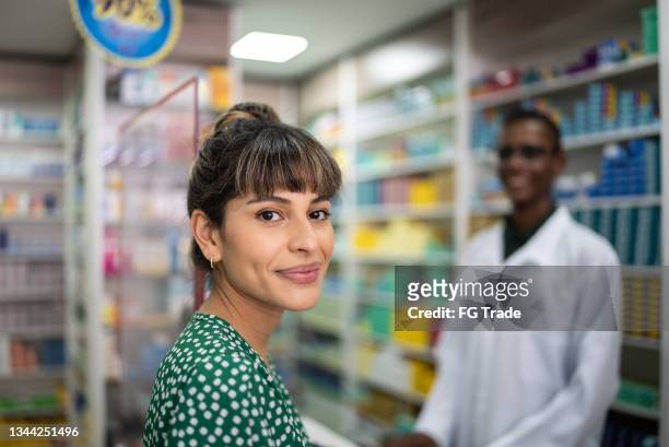 portrait of a young woman at the pharmacy - pharmacist and customer stock pictures, royalty-free photos & images