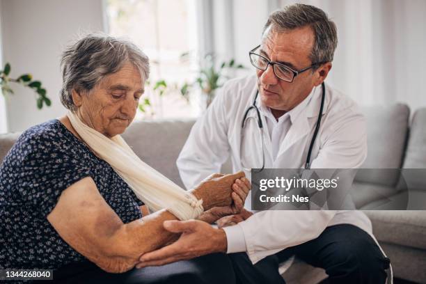 an older woman's arm injury - wound care stock pictures, royalty-free photos & images